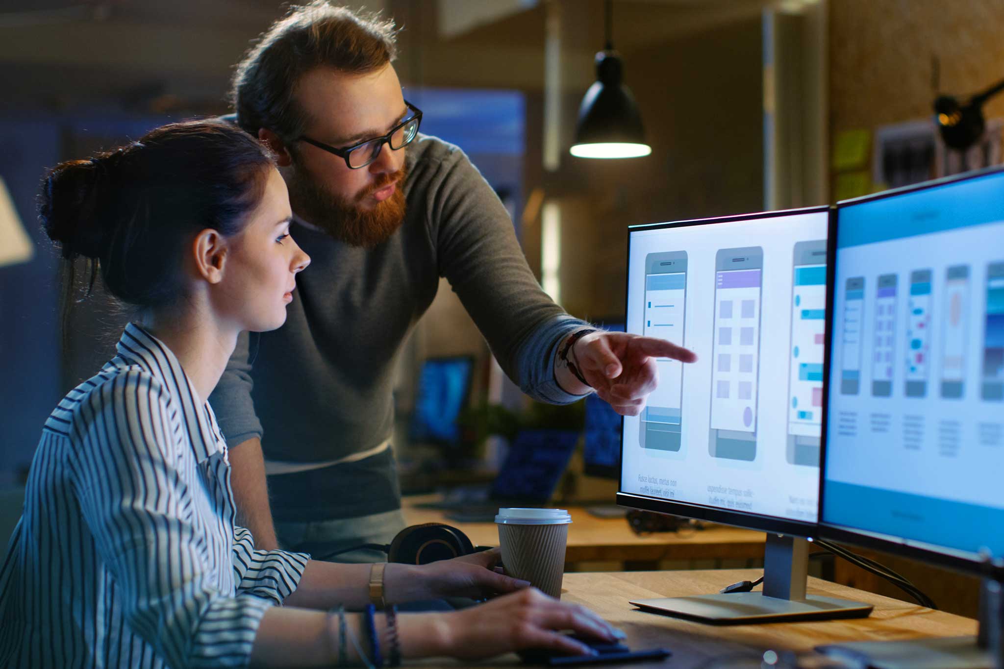 A designer studying layered data visualizations and interface elements